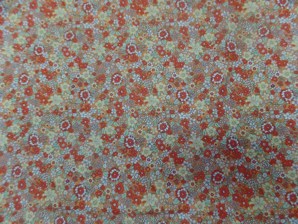 Coton popeline orange imprime liberty motifs petite fleurs