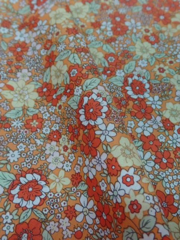 Coton popeline orange imprime liberty motifs petite fleurs