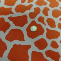 tissu Lycra double face imprimé girafe ton orange et blanc
