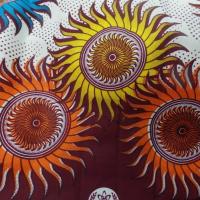 vente de tissu africain wax blanc imprimé soleil ton bordeaux ,orange ,jaune ,bleu